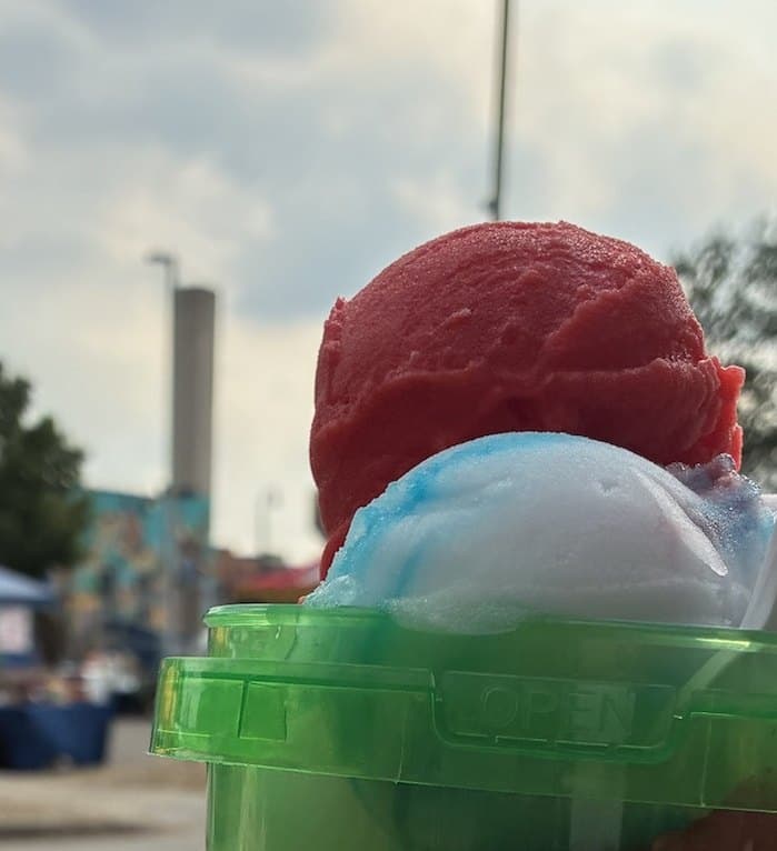 Red and blue Philly water ice scoops piled in a Sno Bar bucket